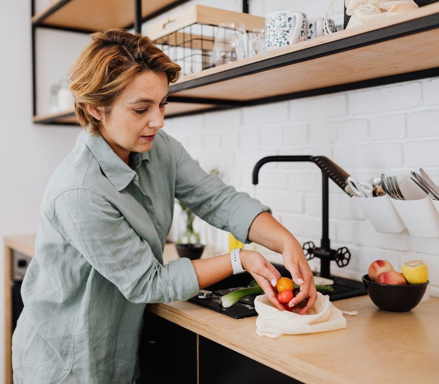 Woman preparing fresh vegetables in a bright modern kitchen
