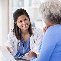 Patient describing health concern to doctor