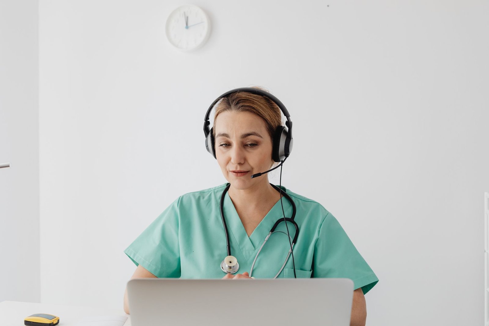 Doctor consulting with a patient online via laptop