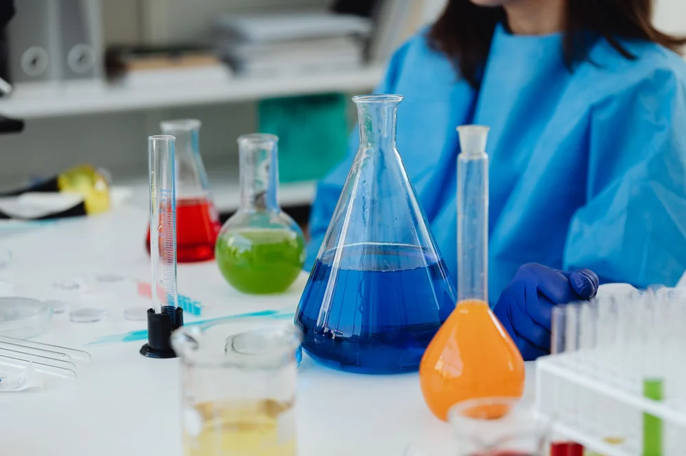 Analytical laboratory technician pipetting in vitro research samples