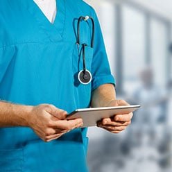 Doctor reviewing medical chart on tablet